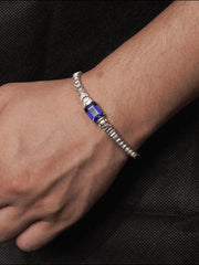 Padparadscha emerald-cut tennis bracelet with hand-set setting detail view showcasing the jewelry design and finish