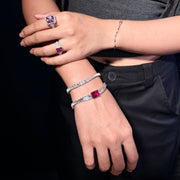 DREXEY pink gemstone tennis bracelet and radiant-cut halo ring styled with black clothing