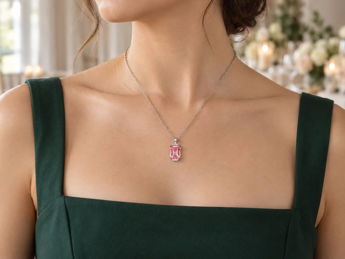 MAREA Sunrise Padparadscha Sapphire necklace styled with a green wedding guest dress