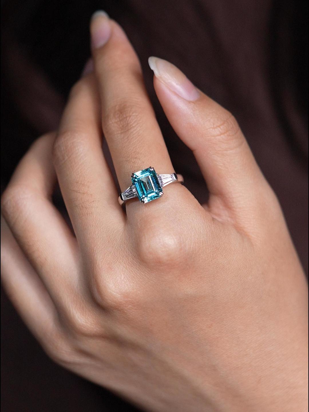 Sapphire emerald-cut ring with hand-set setting close-up view highlighting the gemstone cut and setting details