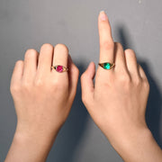 NOMI pink and green bezel-set gemstone rings shown together on two hands