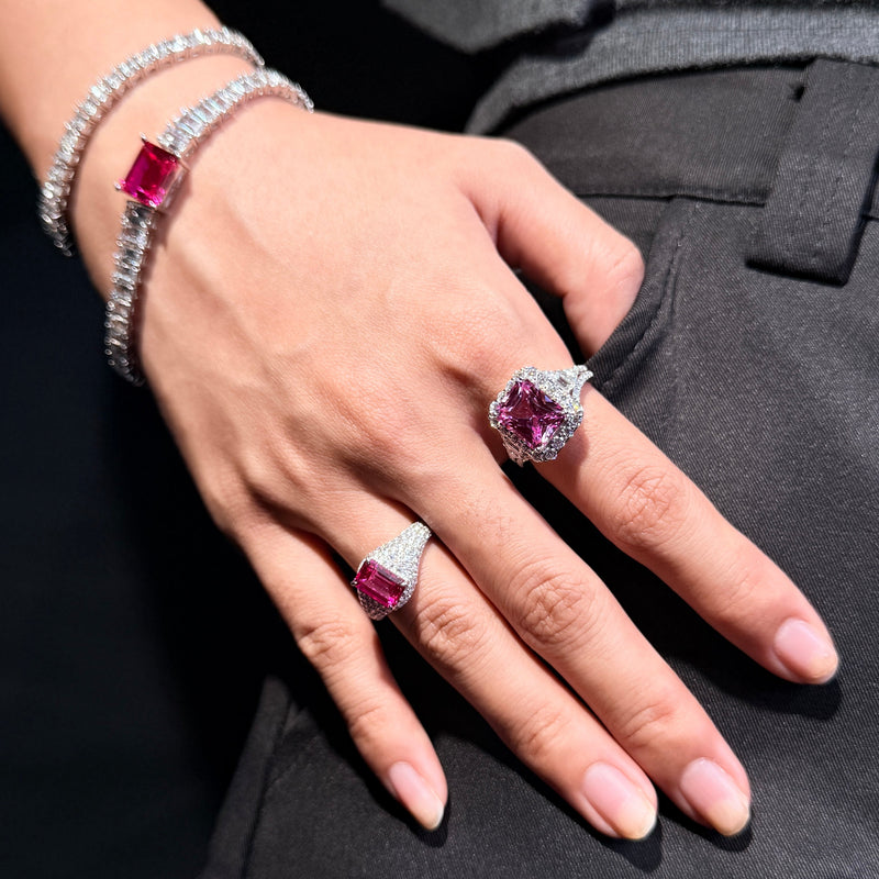 REINE pink gemstone halo ring shown close up with a pink tennis bracelet and pav¨¦ ring